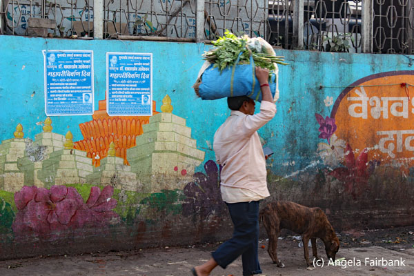 man carrying vegetables on head
