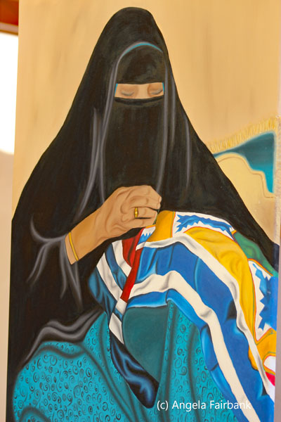 painting of woman sewing